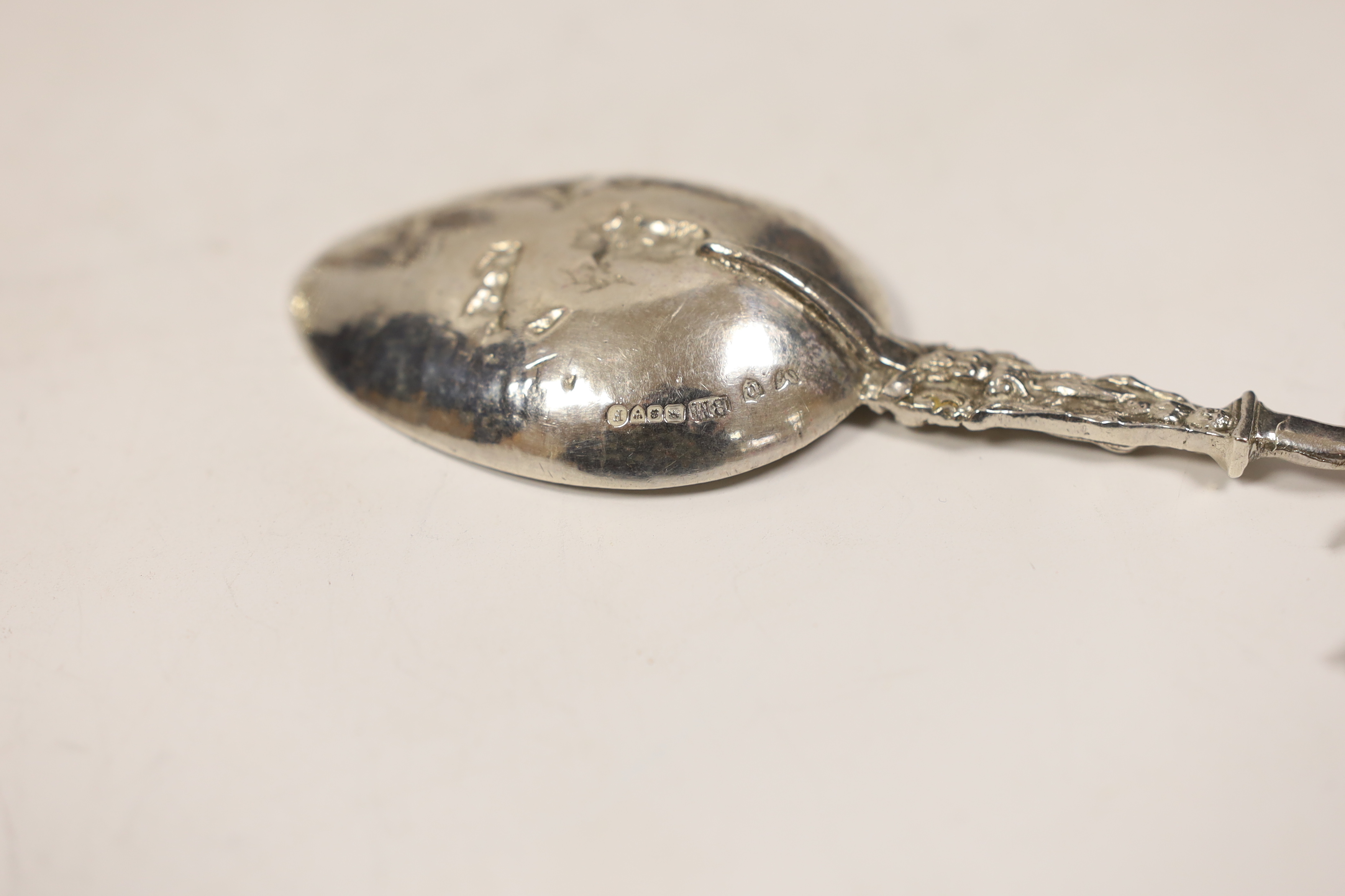 Small silver including a pair of Edwardian silver pepperettes, London, 1906, two continental import marked silver spoons, a silver dish, Georgian wine label and a cased set of four silver and enamel bridge pencils, impor